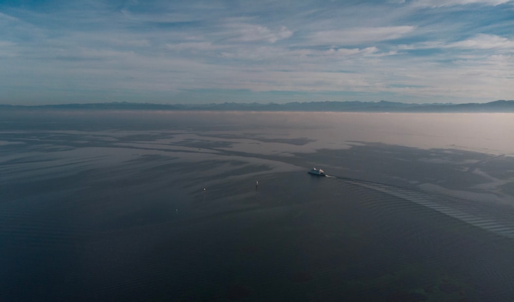 black boat on body of water during daytime