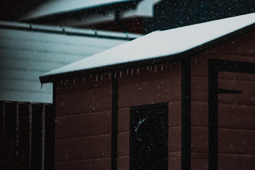 brown wooden house covered with snow
