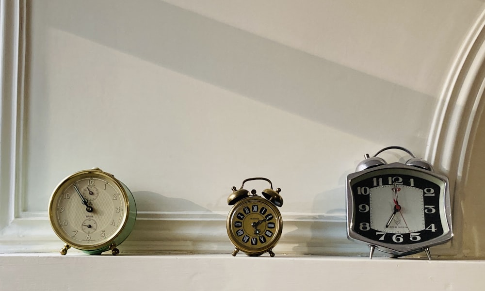 black and silver analog alarm clock