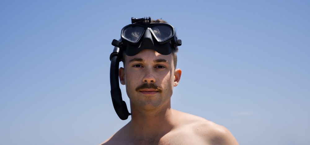 man wearing black goggles under blue sky during daytime