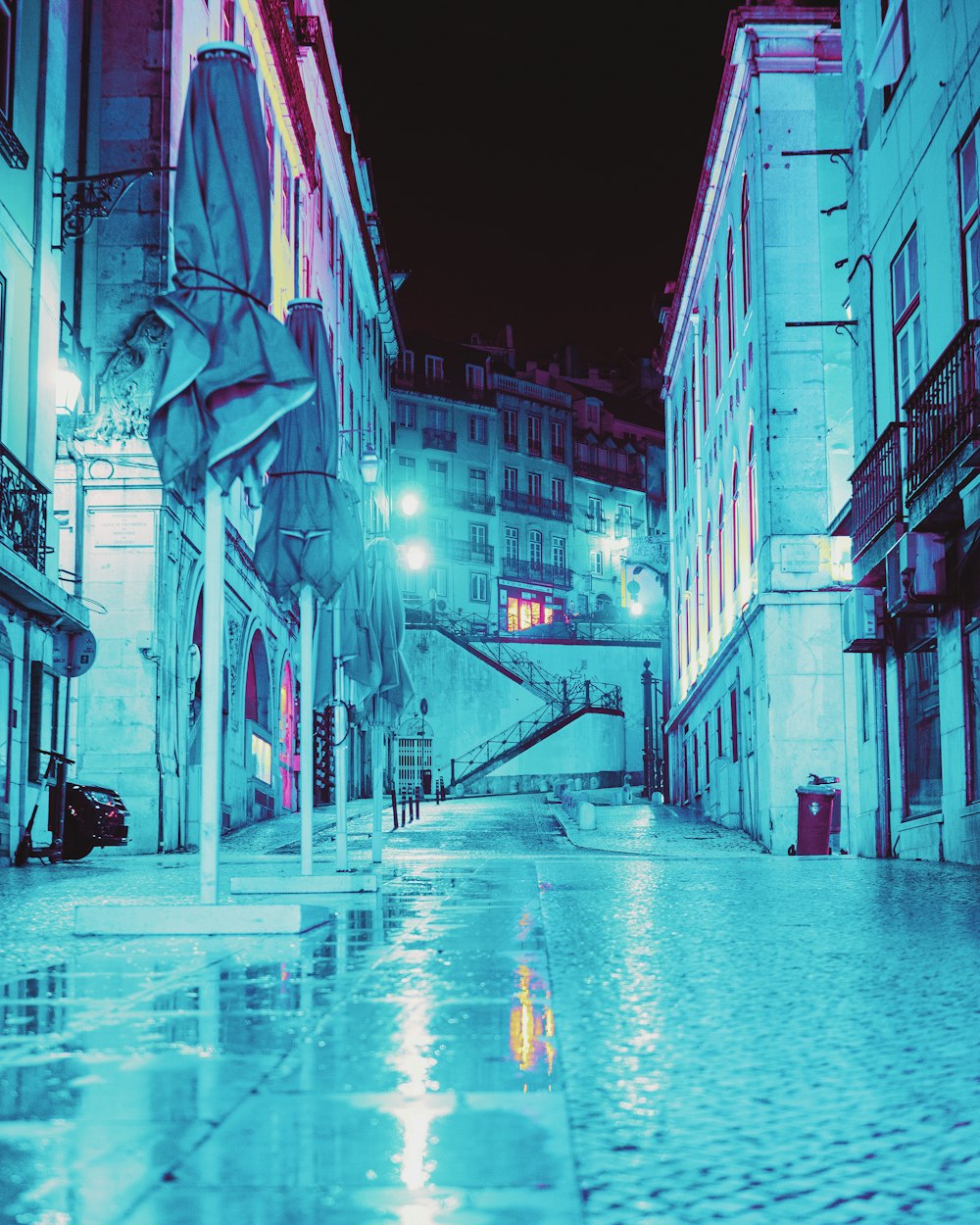 man in black jacket walking on street during night time