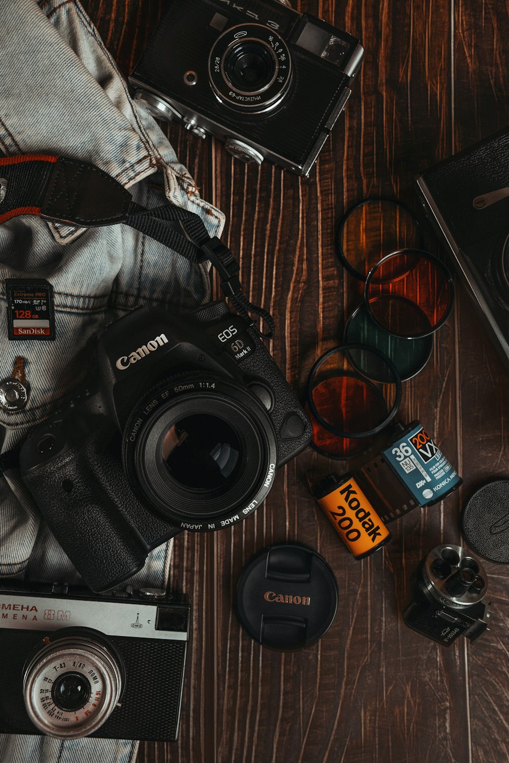 black nikon dslr camera beside black framed sunglasses