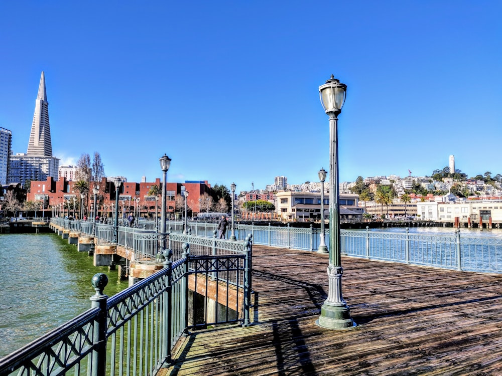 brown wooden dock with lamp post