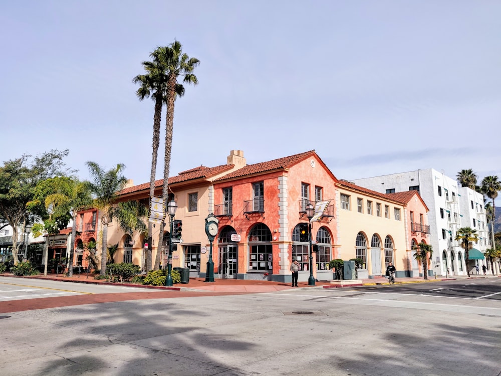 white and brown concrete building near palm trees during daytime