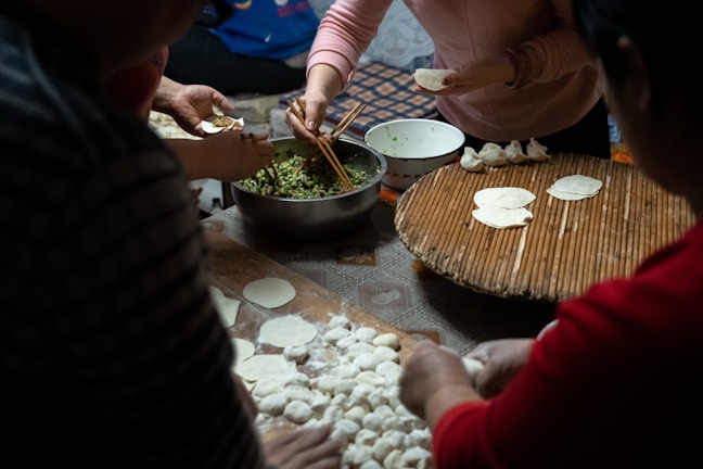 A family participating in a hands-on dumpling-making workshop with a local chef.