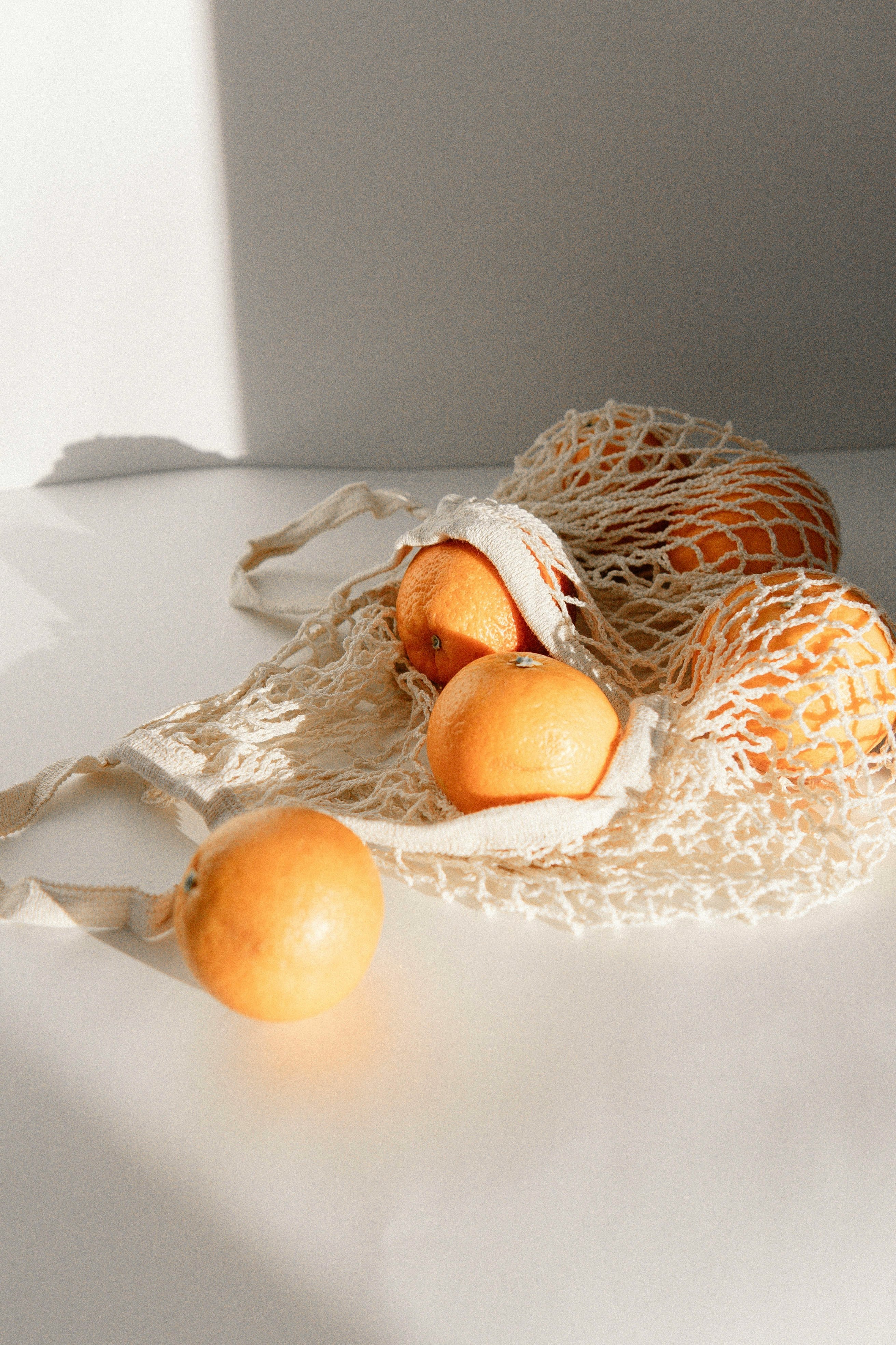 orange fruits on white net