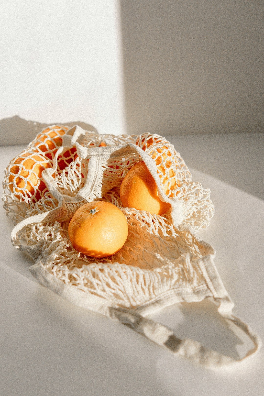orange fruit on white knit textile