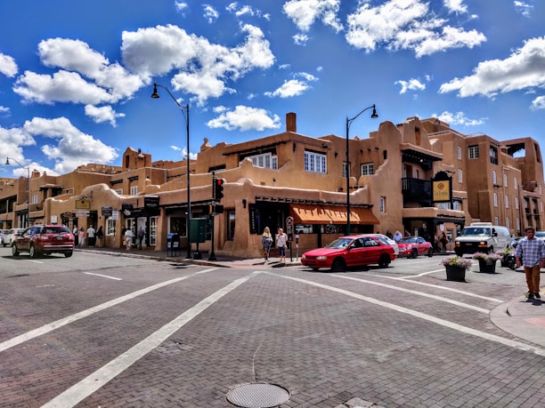 A scenic view of Santa Fe town with business buildings and regional maps overlayed.