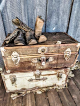 Rustic decorative storage trunk placed at the foot of a bed, adding charm and extra space.