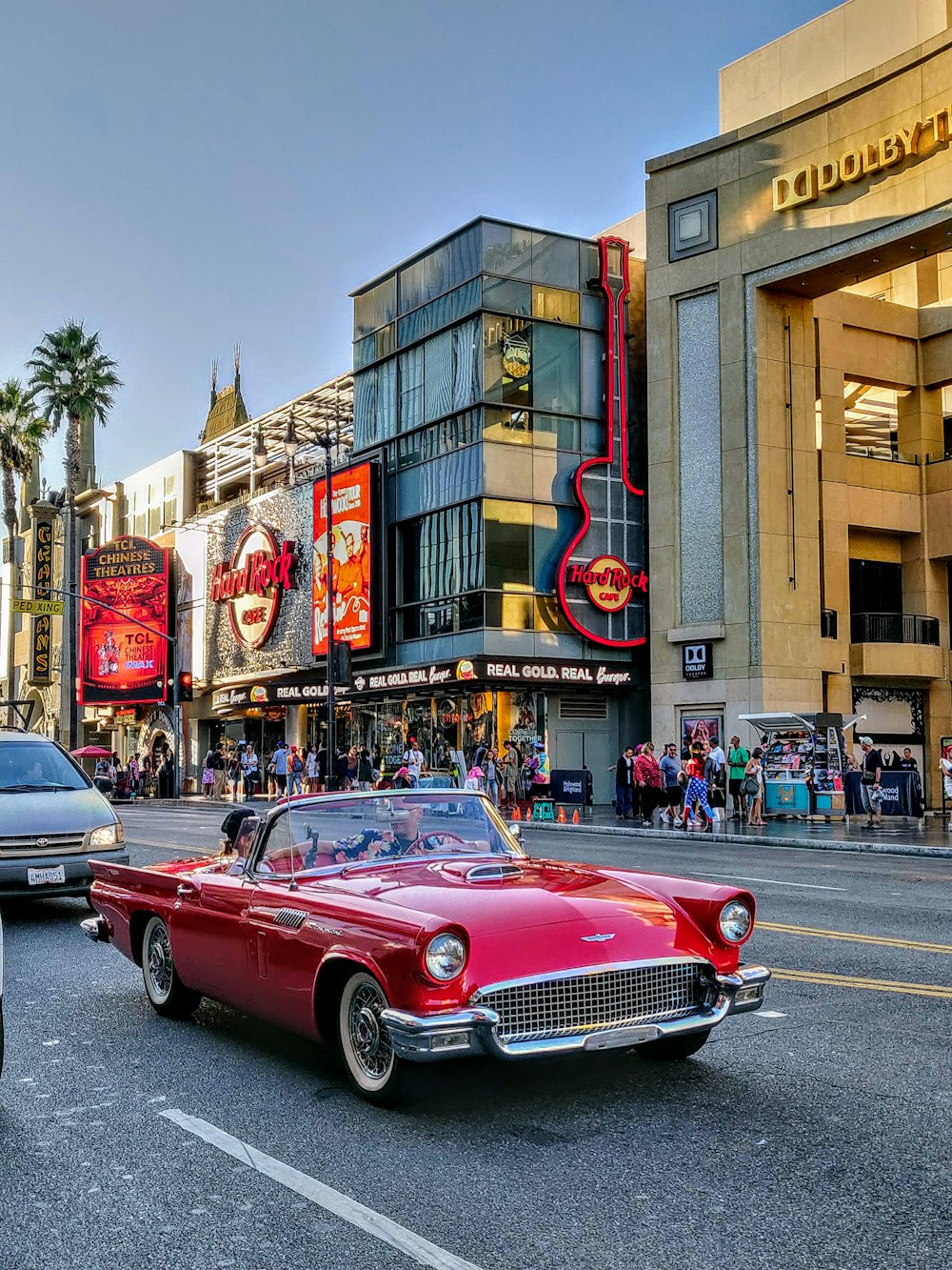 red convertible car on road during daytime