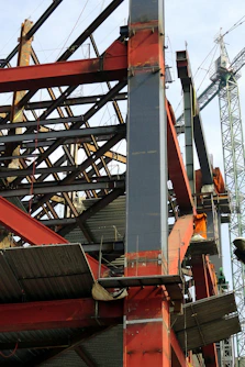 Close-up of construction site showing structural steel framework and safety measures.
