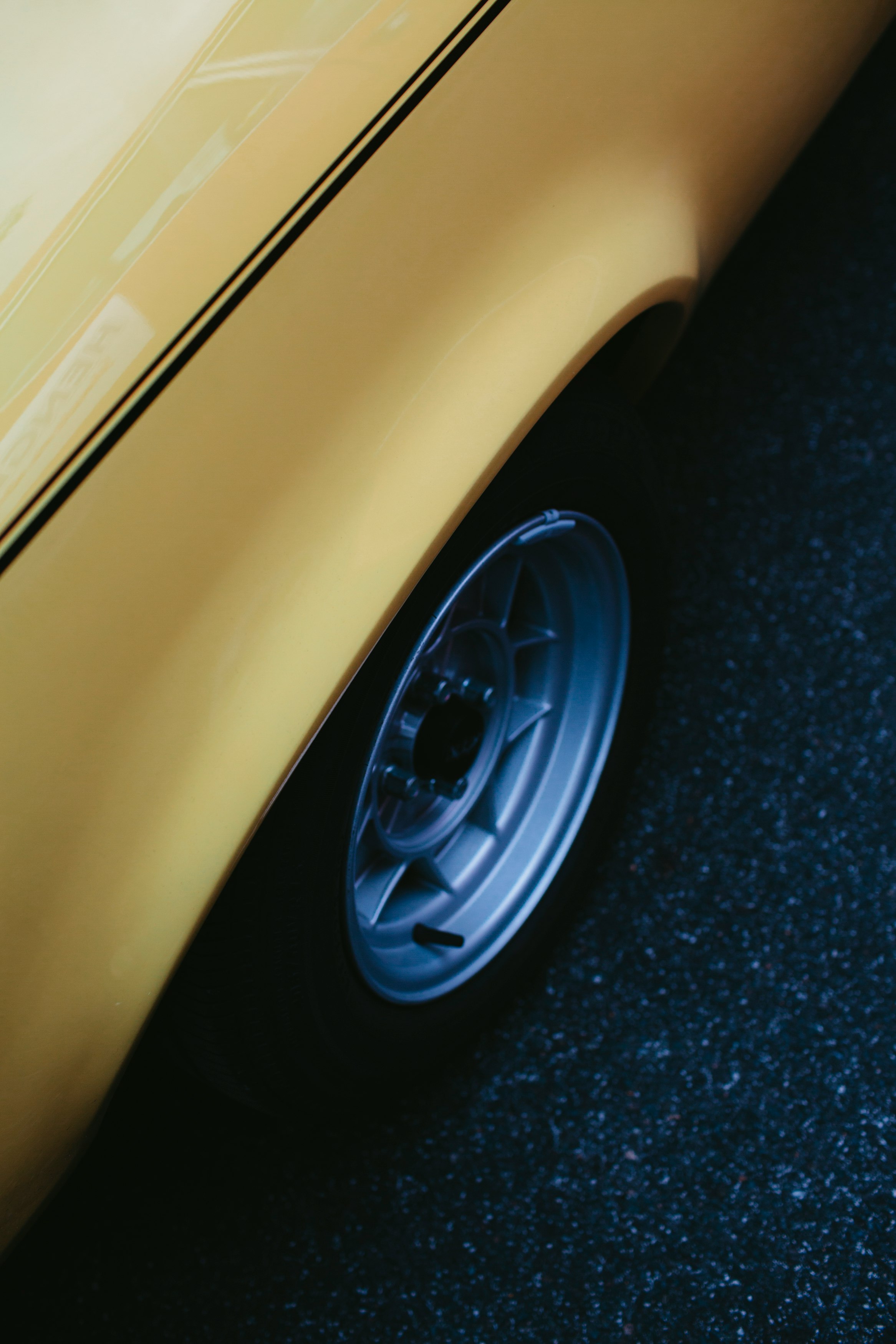 yellow car on black asphalt road