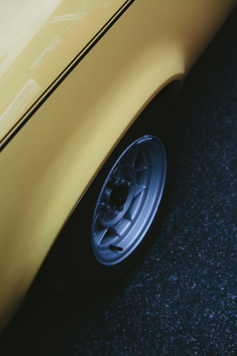 yellow car on black asphalt road