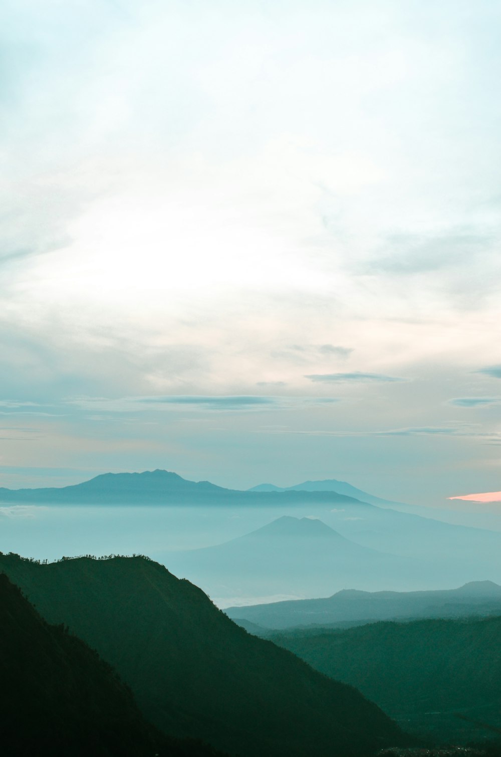 green mountains under white clouds during daytime