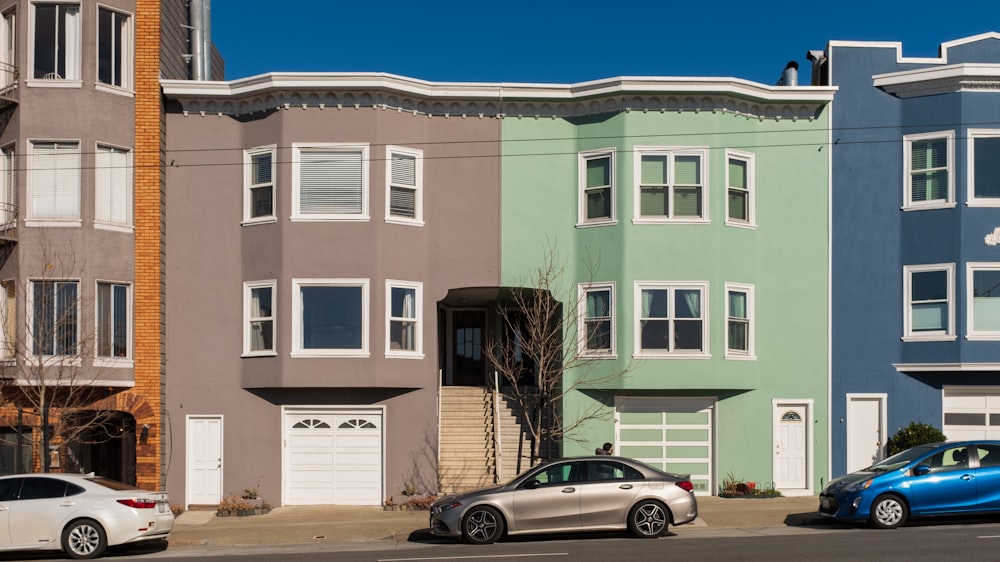 silver sedan parked in front of brown concrete building during daytime