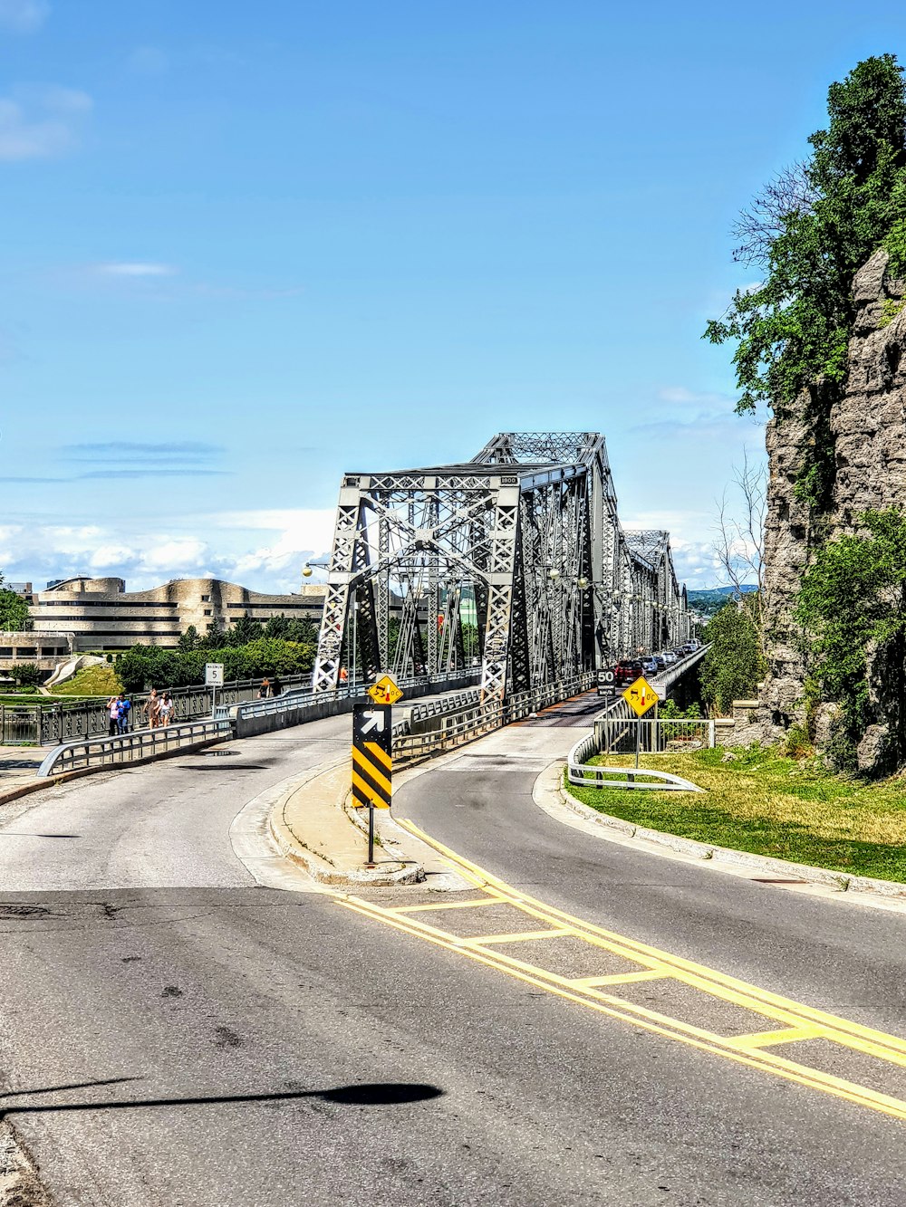 gray concrete road with cars passing by