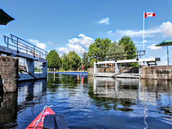 white and brown wooden bridge over river during daytime