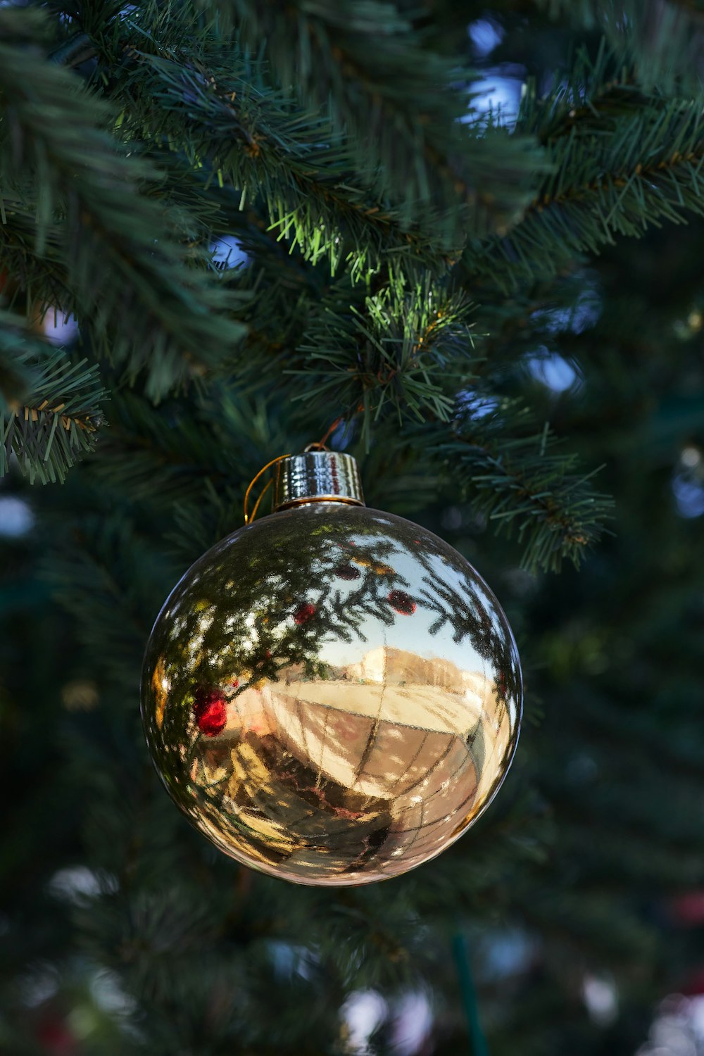 gold bauble on green christmas tree