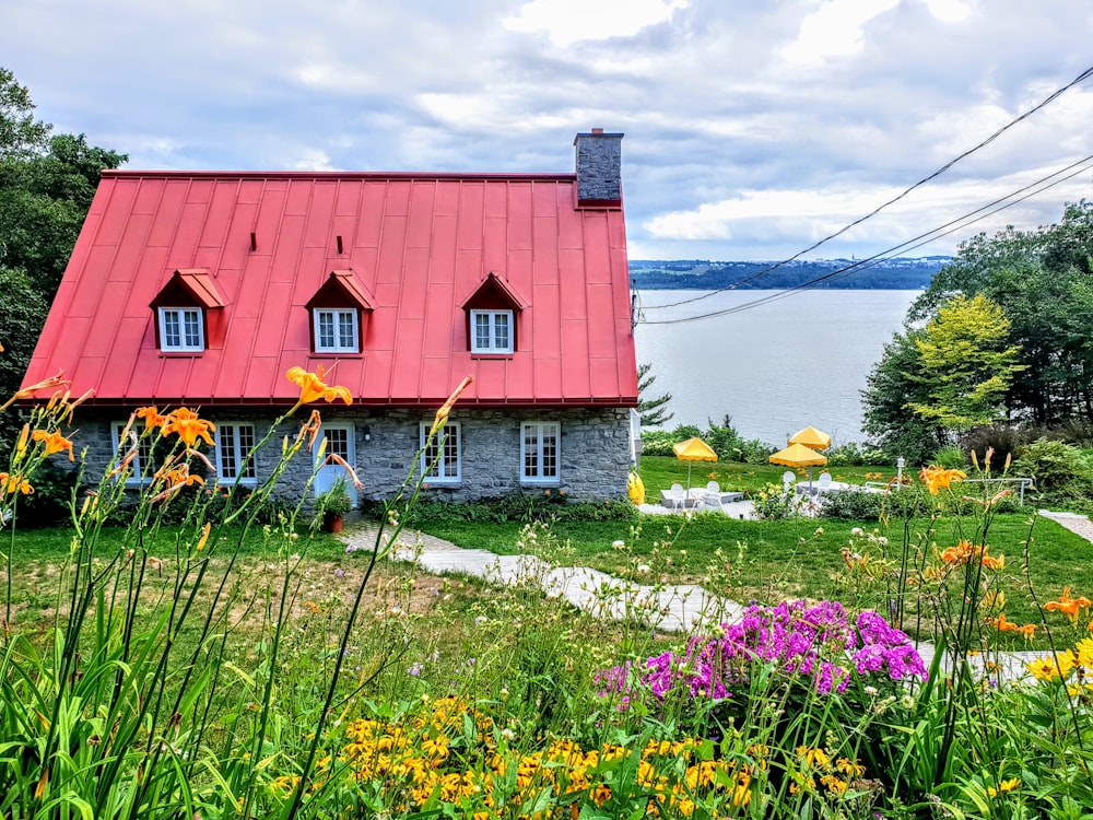 red and white house near body of water during daytime