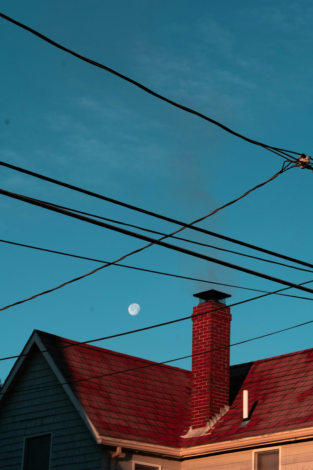  red brick building under blue sky chimney