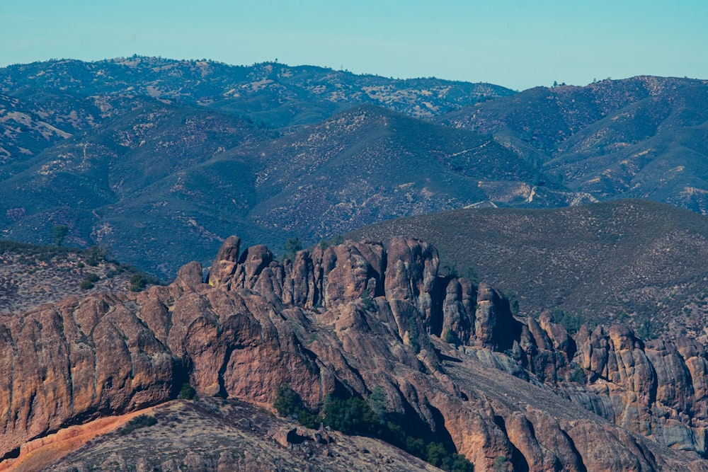 brown rocky mountain under blue sky during daytime