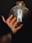 A satisfied customer showcasing a bright bulb from New England Lightening.