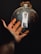 A satisfied customer showcasing a bright bulb from New England Lightening.