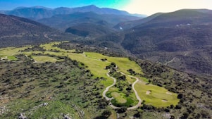 green grass field and mountain during daytime