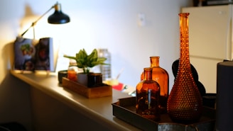 brown glass bottle on white table