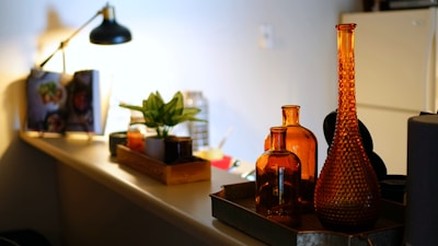 brown glass bottle on white table