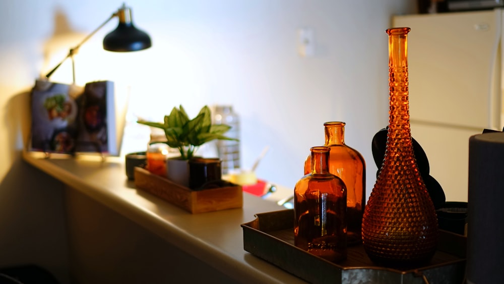 brown glass bottle on white table