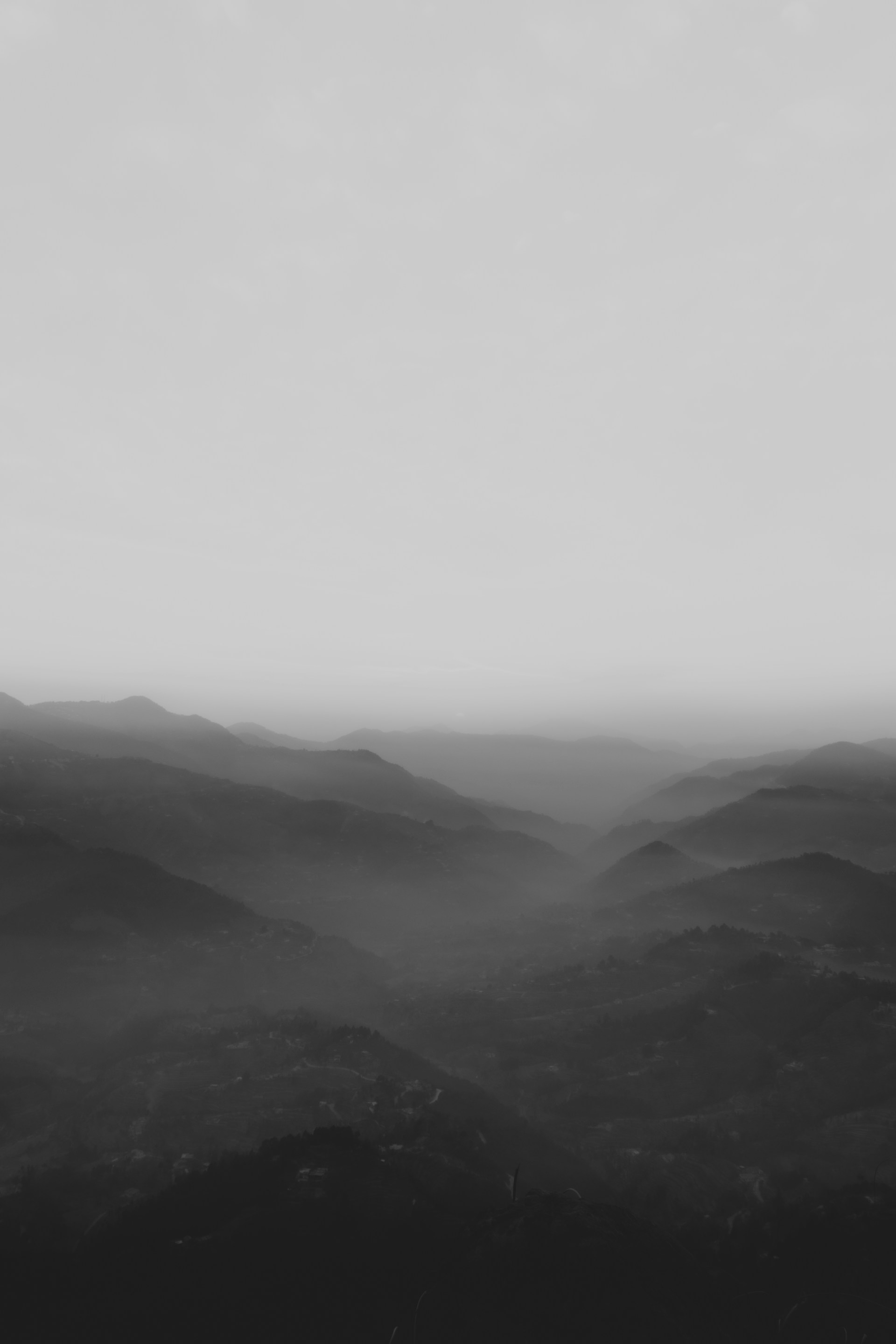 mountains covered with fog during daytime