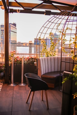 Rooftop garden space with comfortable seating and city views in soft evening light.