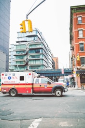 red and white van on road near building during daytime