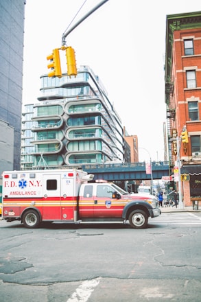 red and white van on road near building during daytime