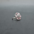 Stacked rings with subtle sparkle resting on a pastel pink background.