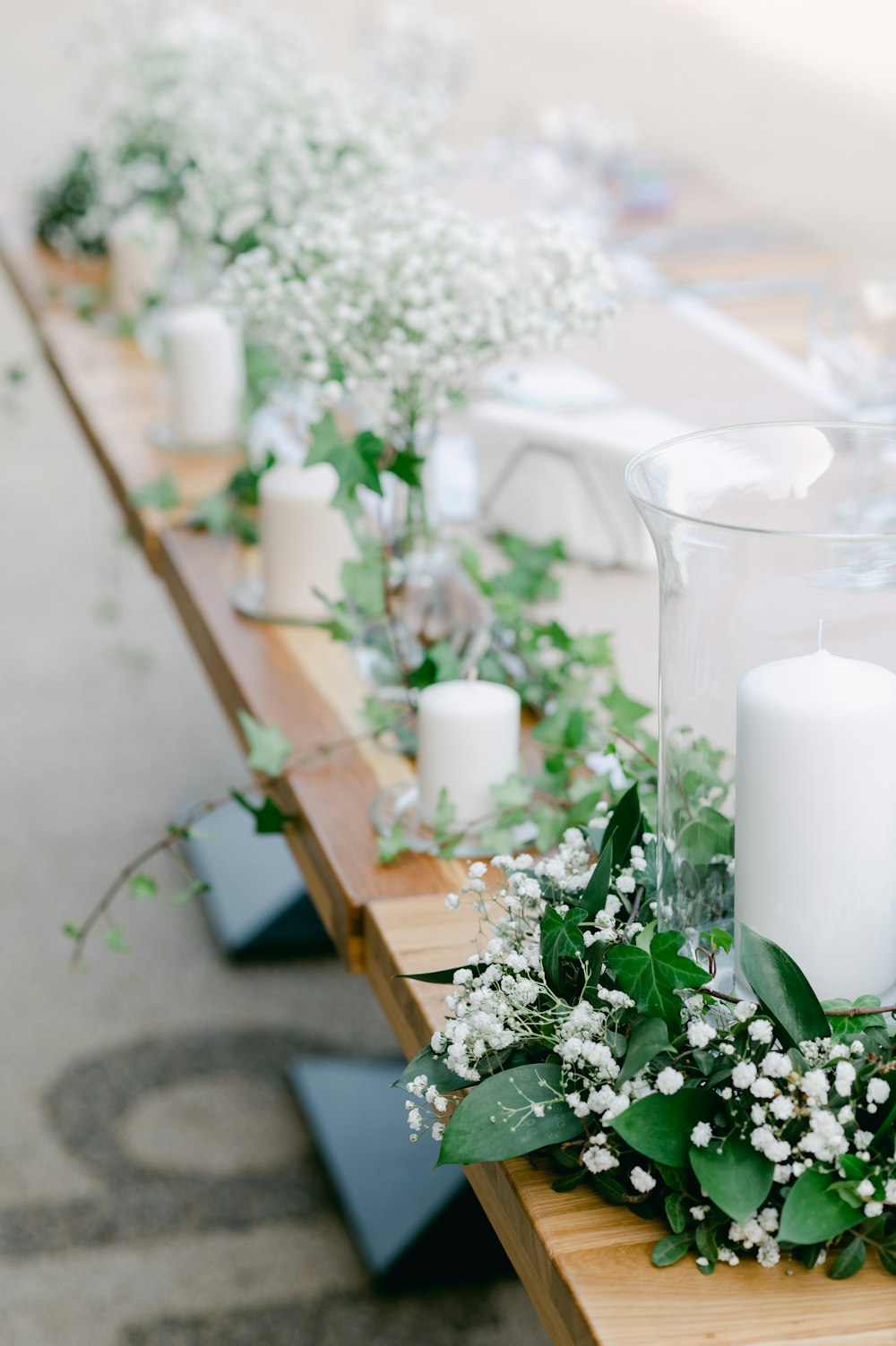 white pillar candle on brown wooden table