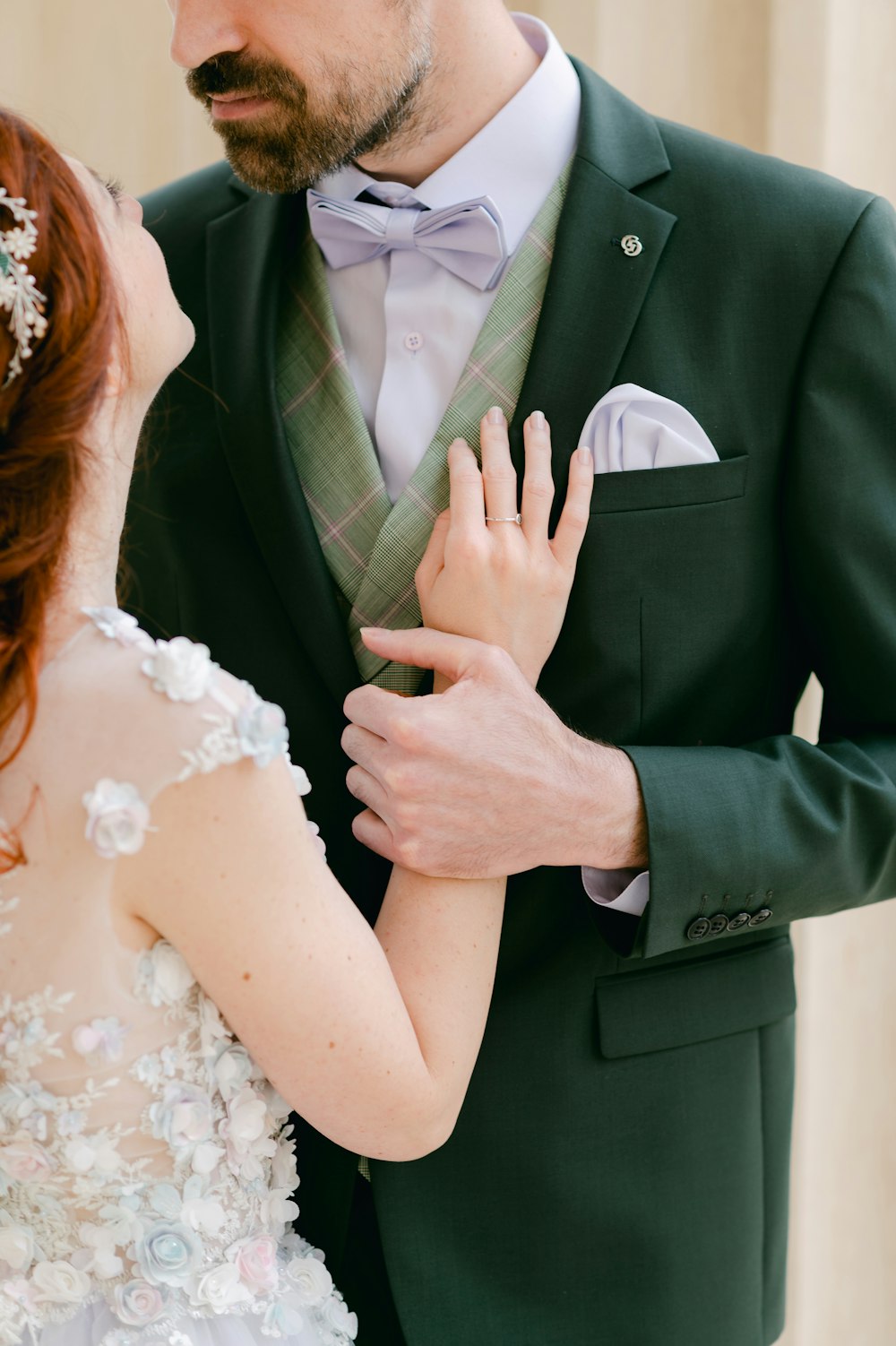 man in black suit jacket kissing woman in white wedding dress