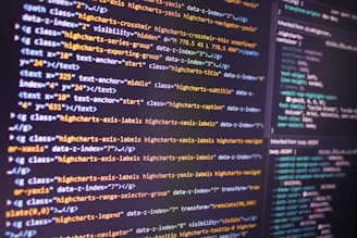 Computer screen displaying HTML or CSS code in orange, yellow, and black, illustrating programming 