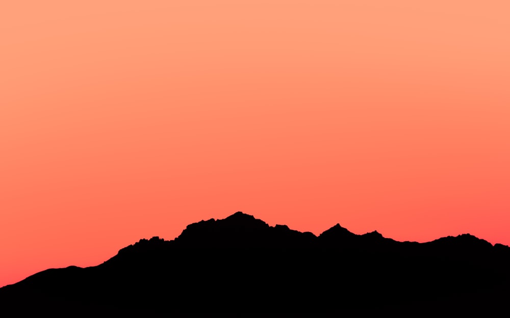 silhouette of mountain during sunset