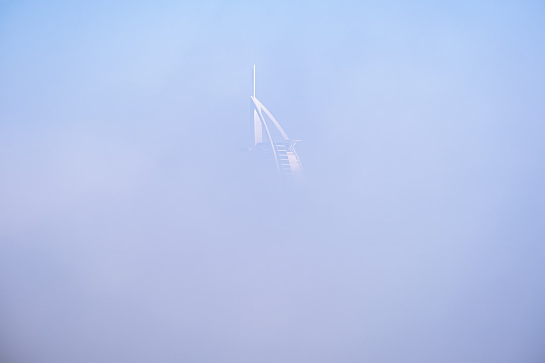 white wind turbine under blue sky