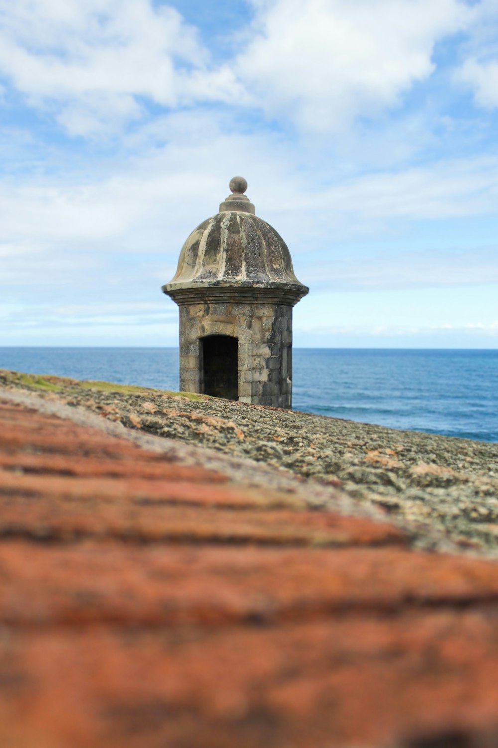 gray concrete building near sea under blue sky during daytime