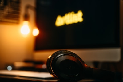 A cozy home setup with headphones and a laptop open to a music download page.