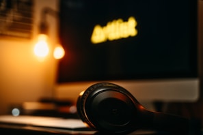 Modern headphones placed casually on a cozy couch with a blurred background