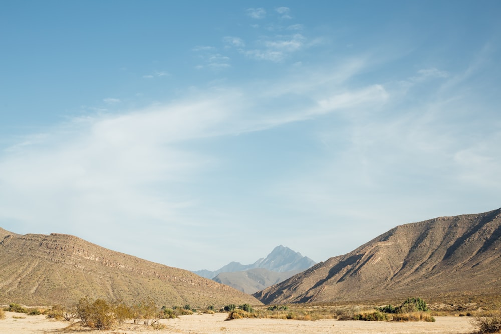 brown and green mountains under blue sky during daytime