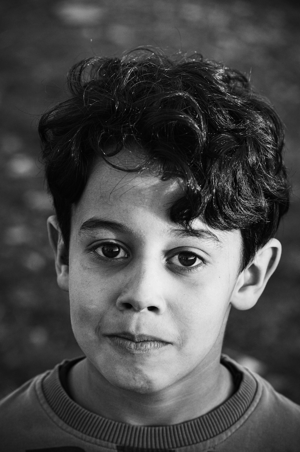grayscale photo of boy in collared shirt