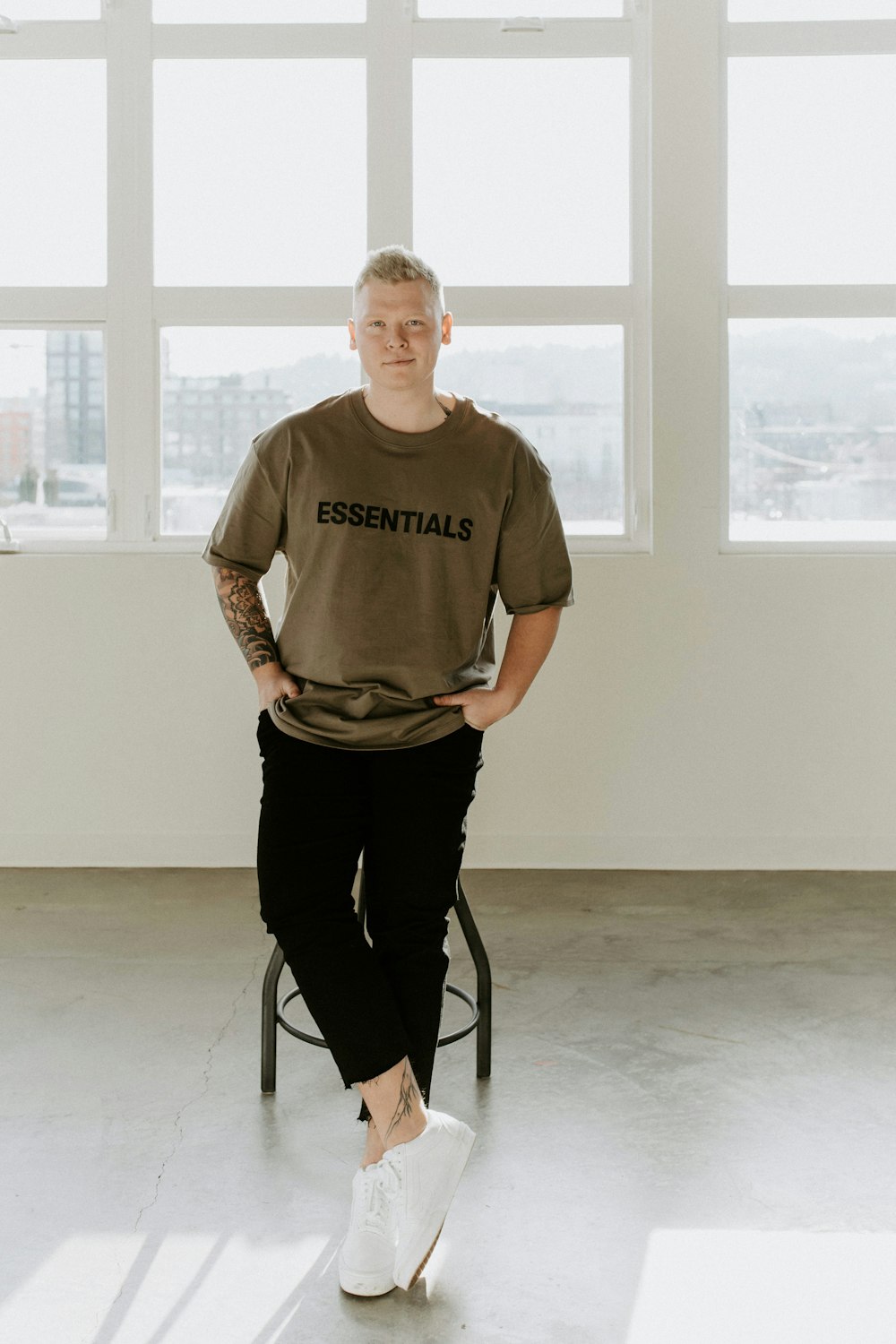 man in gray crew neck t-shirt sitting on chair