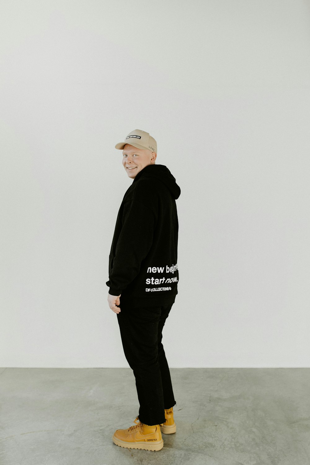 man in black hoodie and black pants standing