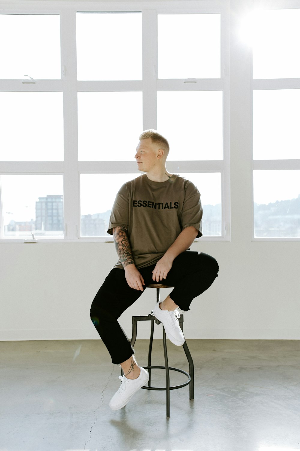 man in brown crew neck t-shirt sitting on chair