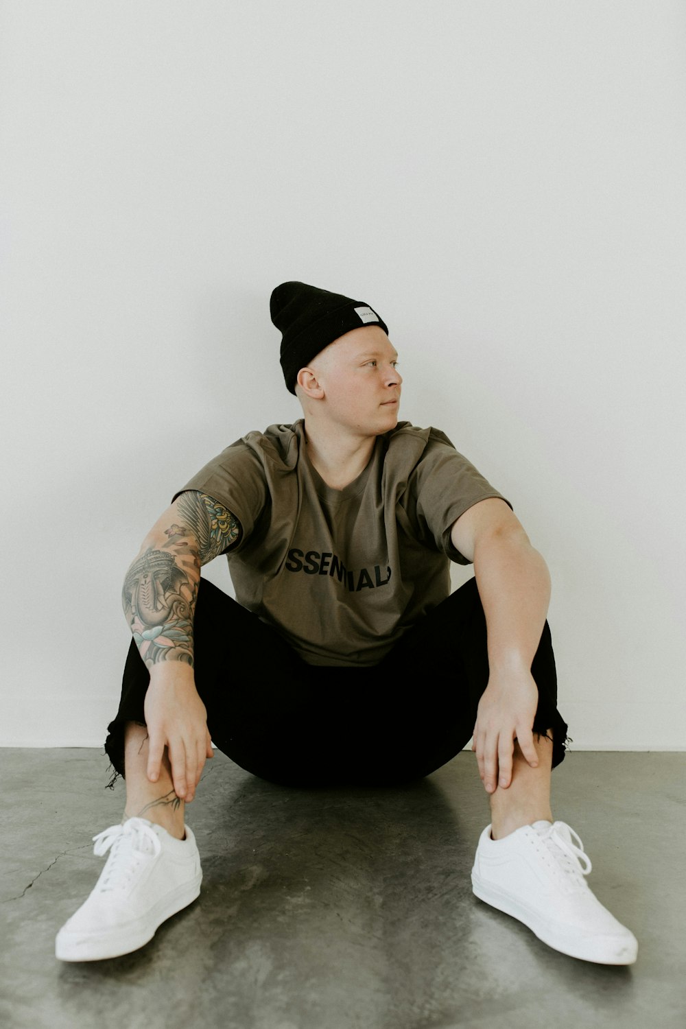 man in black crew neck t-shirt and black pants sitting on floor